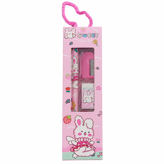 A pink stationery set in a matching retail box with a heart-shaped loop at the top. The set includes a pink pen, a small pink ruler or eraser-like tool, and a small white-and-pink item, all decorated with bunny and strawberry illustrations.