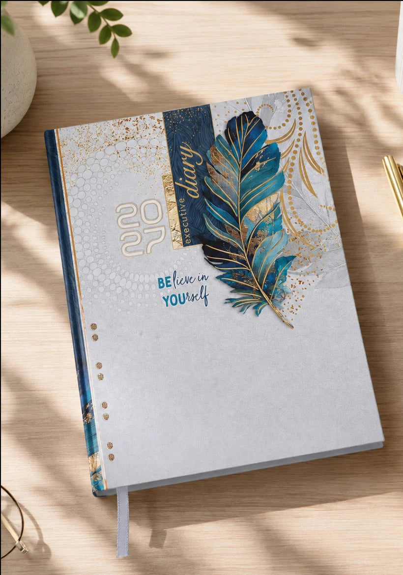 2027 cream, blue and gold paper pasting executive diary with decorative feather cover, blue patterned spine, Believe in Yourself lettering, and ribbon bookmark.