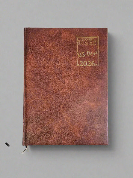 Brown leather diary with '2026' on a gray background